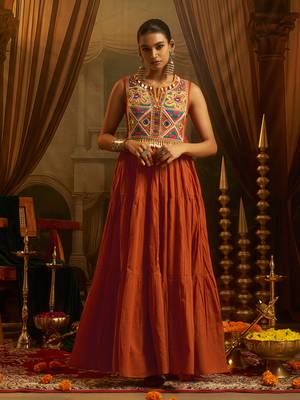 Elevate festive style with this rust orange gown featuring intricate mirror and thread embroidery. 5