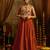 Elevate festive style with this rust orange gown featuring intricate mirror and thread embroidery.