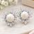 Elegant pearl and crystal floral stud earrings with silver-tone finish
