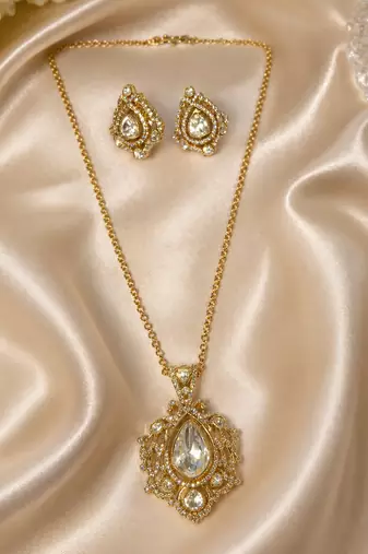 Elegant gold-tone teardrop pendant necklace set with matching stud earrings