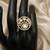 Elegant gold-tone round statement ring with clear stone studded design
