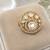 Elegant gold-tone round statement ring with clear stone studded design