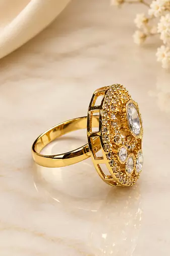 Elegant gold-tone round statement ring with clear stone studded design