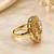 Elegant gold-tone round statement ring with clear stone studded design