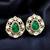 Emerald green teardrop stone gold-tone studded earrings