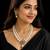 Elegant pearl beaded necklace set with ruby-coloured stones & kundan work