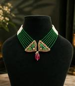 Elegant green beaded necklace with artistic pendant and ruby-tone drop