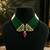 Elegant green beaded necklace with artistic pendant and ruby-tone drop