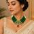 Elegant green beaded necklace with artistic pendant and ruby-tone drop