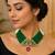Elegant green beaded necklace with artistic pendant and ruby-tone drop