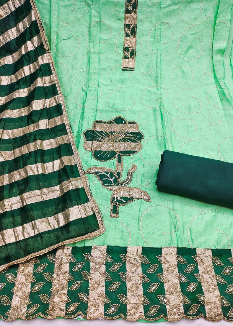 Green cotton embroidered unstitched dress material.