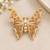 Elegant gold-plated butterfly brooch with pink and clear stone detailing
