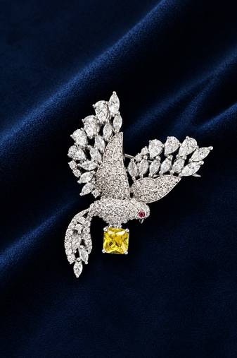 Elegant peacock design brooch with yellow stone and crystal studded detailing