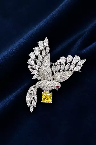 Elegant peacock design brooch with yellow stone and crystal studded detailing