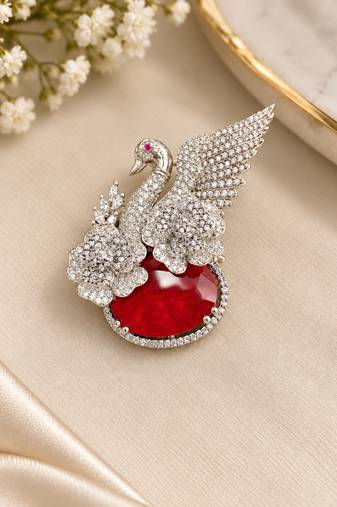 Elegant swan brooch with red crystal and wing shaped cz stone detailing