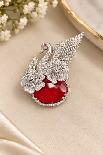 Elegant swan brooch with red crystal and wing shaped cz stone detailing