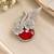 Elegant swan brooch with red crystal and wing shaped cz stone detailing