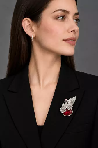 Elegant swan brooch with red crystal and wing shaped cz stone detailing