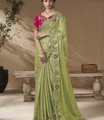 designer green viscose fabric saree with rani pink silk blend blouse fabric