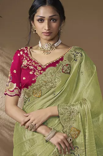 designer green viscose fabric saree with rani pink silk blend blouse fabric