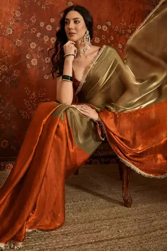 Orange tissue satin embellished saree with unstitched blouse piece.