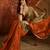 Orange tissue satin embellished saree with unstitched blouse piece.
