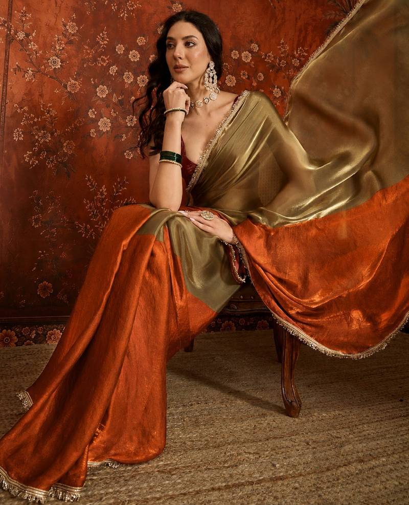 Orange tissue satin embellished saree with unstitched blouse piece.