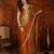 Orange tissue satin embellished saree with unstitched blouse piece.