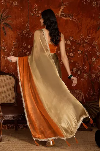 Orange tissue satin embellished saree with unstitched blouse piece.