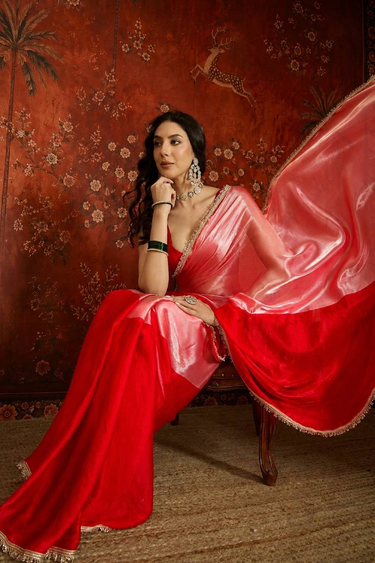 Red tissue satin embellished saree with unstitched blouse piece.