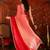 Red tissue satin embellished saree with unstitched blouse piece.