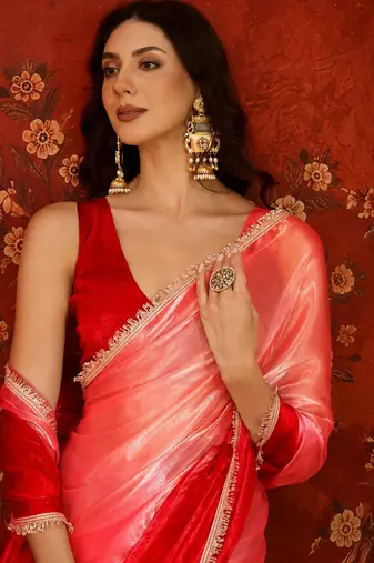 Red tissue satin embellished saree with unstitched blouse piece.