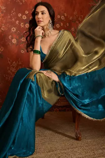 Teal tissue satin embellished saree with unstitched blouse piece.