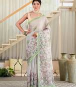 kusumita linen saree with hand painted flowers. sequence work over them. blouse fabric given inside the saree.