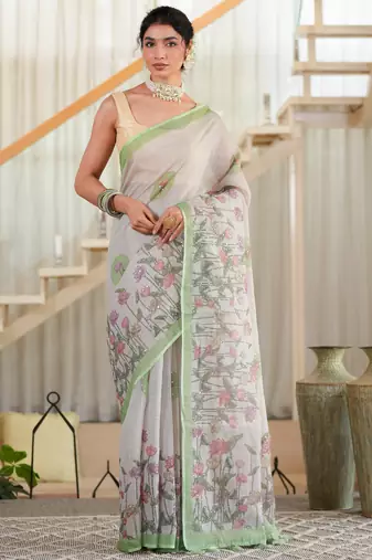 kusumita linen saree with hand painted flowers. sequence work over them. blouse fabric given inside the saree.