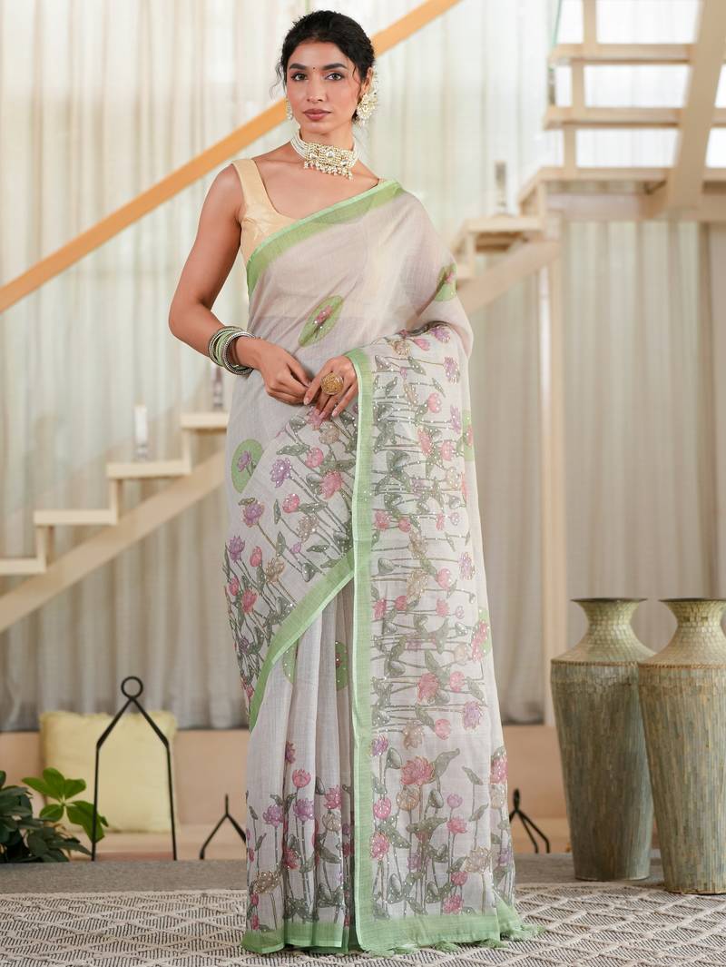 kusumita linen saree with hand painted flowers. sequence work over them. blouse fabric given inside the saree.
