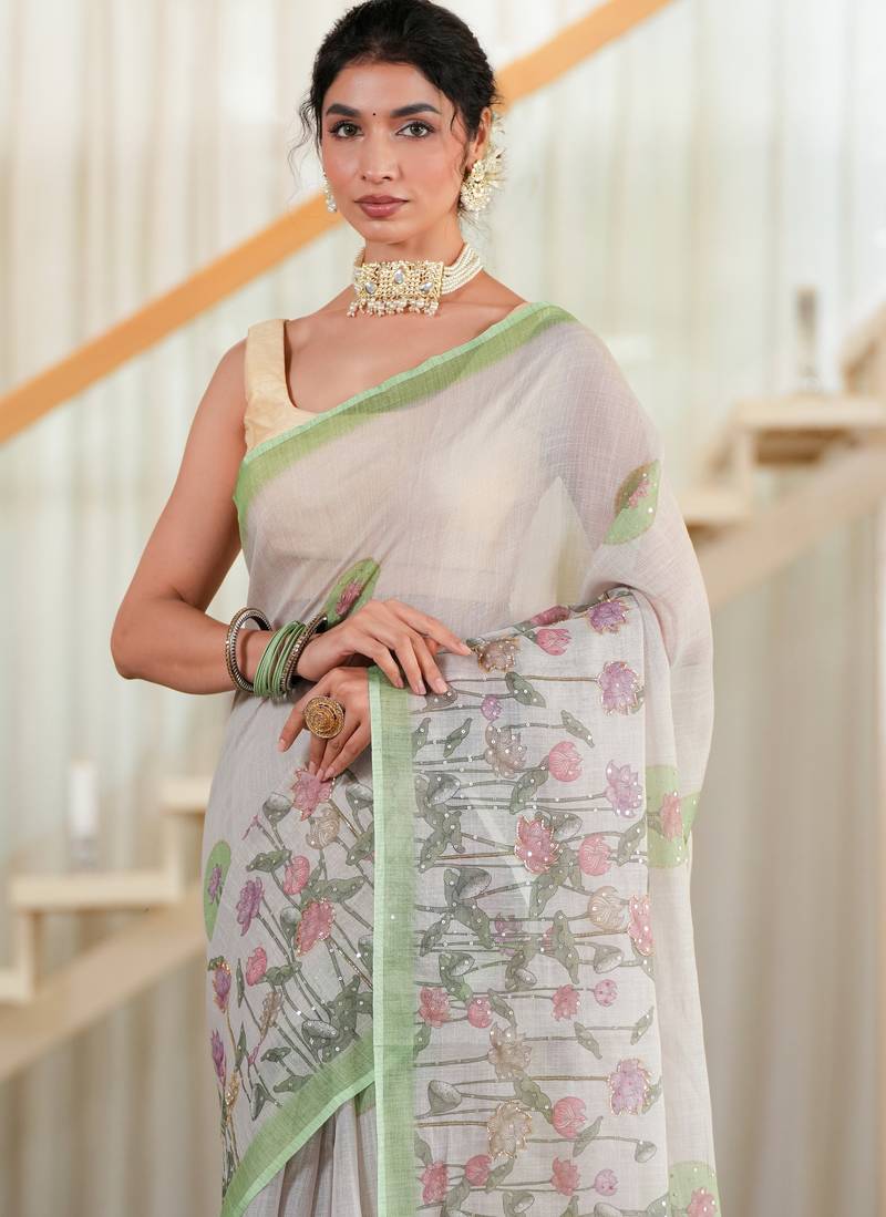 kusumita linen saree with hand painted flowers. sequence work over them. blouse fabric given inside the saree.