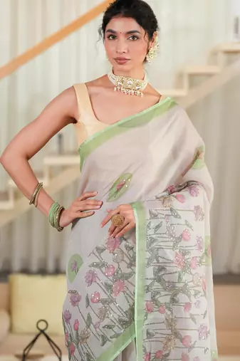 kusumita linen saree with hand painted flowers. sequence work over them. blouse fabric given inside the saree.