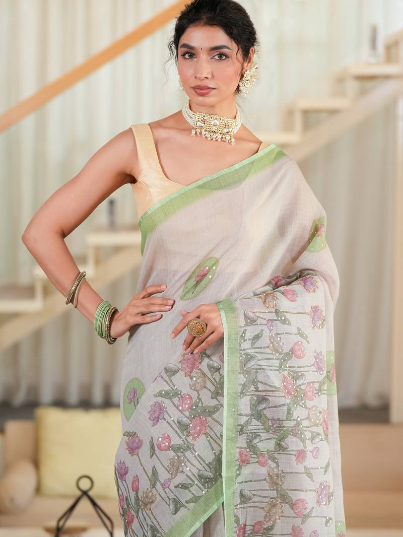 kusumita linen saree with hand painted flowers. sequence work over them. blouse fabric given inside the saree.