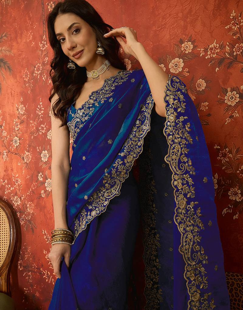 Blue tissue satin embroidered saree with unstitched blouse piece.