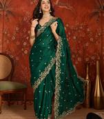 Bottle green tissue satin embroidered saree with unstitched blouse piece.