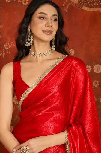 Red tissue satin embrellished saree with unstitched blouse piece.