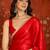 Red tissue satin embrellished saree with unstitched blouse piece.