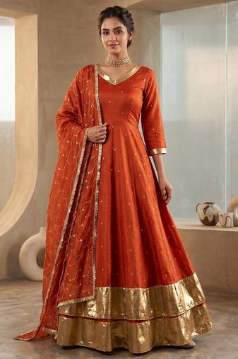 Rust orange silk anarkali suit with golden border and embroidered dupatta