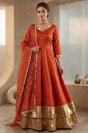 Rust orange silk anarkali suit with golden border and embroidered dupatta