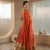 Rust orange silk anarkali suit with golden border and embroidered dupatta