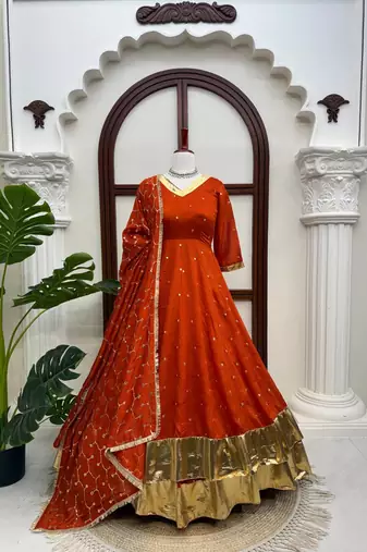 Rust orange silk anarkali suit with golden border and embroidered dupatta