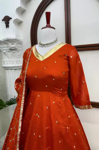 Rust orange silk anarkali suit with golden border and embroidered dupatta