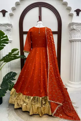 Rust orange silk anarkali suit with golden border and embroidered dupatta