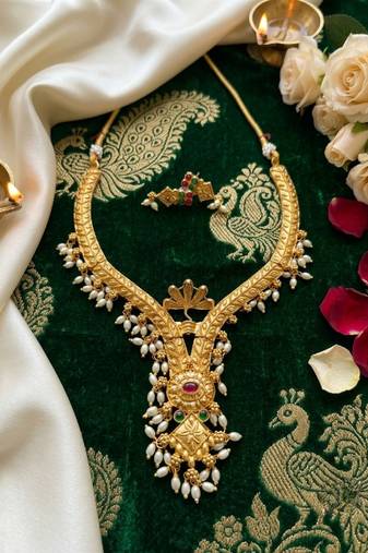 gold plated pearl necklace set with ruby and emerald accents